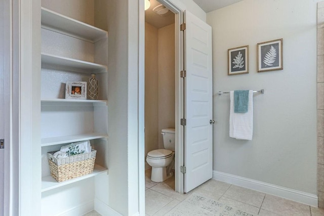 bathroom with tile patterned floors and toilet