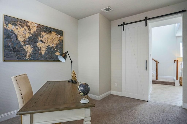 office area with a barn door and carpet