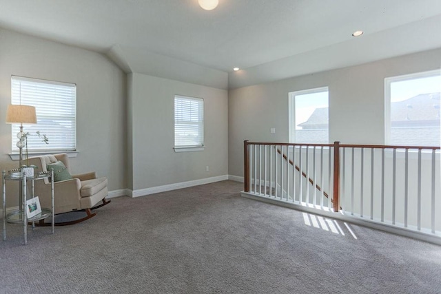 unfurnished room with carpet floors and vaulted ceiling