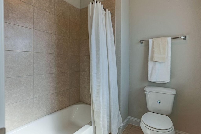 bathroom featuring shower / tub combo, tile patterned floors, and toilet