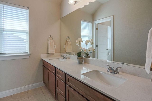 bathroom featuring vanity, lofted ceiling, and tile patterned floors