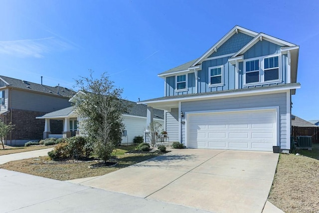 view of front of home with a garage and central AC