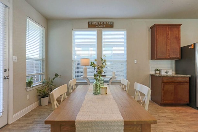 dining room with a healthy amount of sunlight and light wood-type flooring