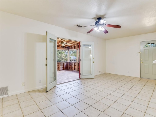 spare room featuring ceiling fan and light tile patterned floors