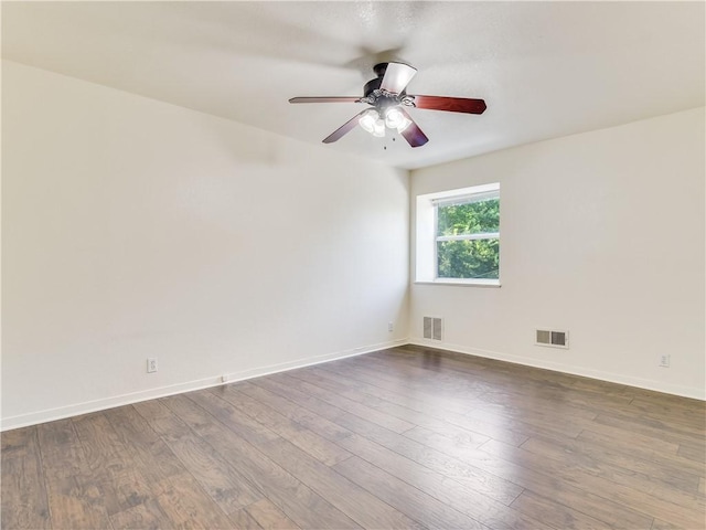 spare room with hardwood / wood-style flooring and ceiling fan