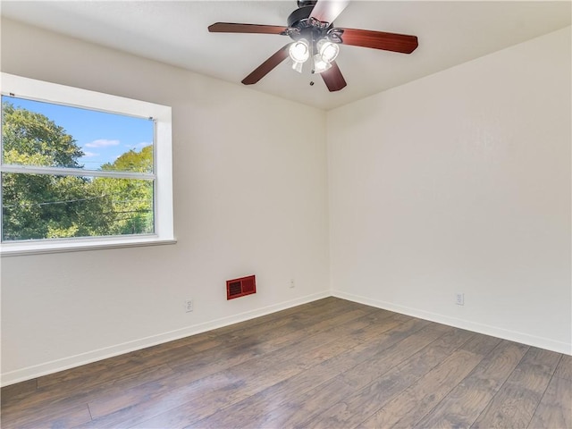 spare room featuring ceiling fan and dark hardwood / wood-style flooring