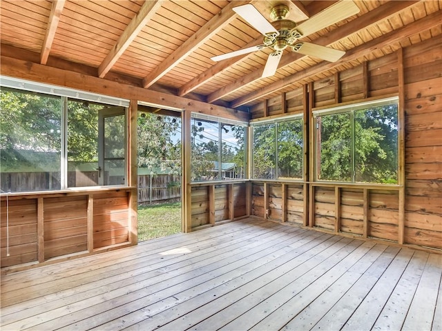 unfurnished sunroom featuring ceiling fan, lofted ceiling with beams, and wooden ceiling