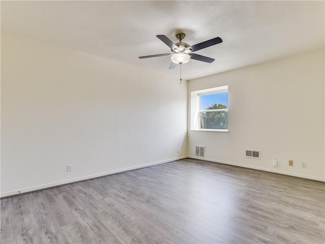 spare room featuring ceiling fan and light wood-type flooring