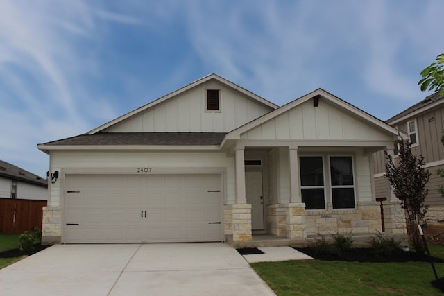 2407 Ekvall Dr, Round Rock, TX 78665 - craftsman house featuring stone siding, concrete driveway, a garage, and board and batten siding