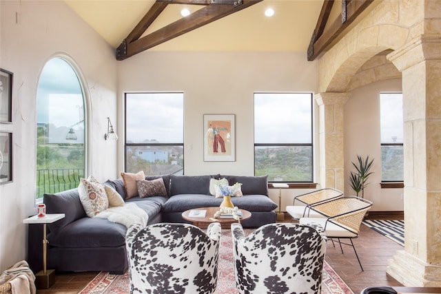 living room featuring dark hardwood / wood-style flooring, lofted ceiling with beams, and ornate columns