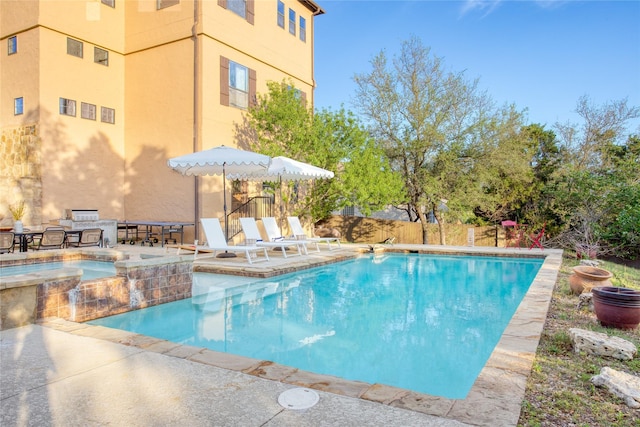 view of pool featuring a patio and an in ground hot tub