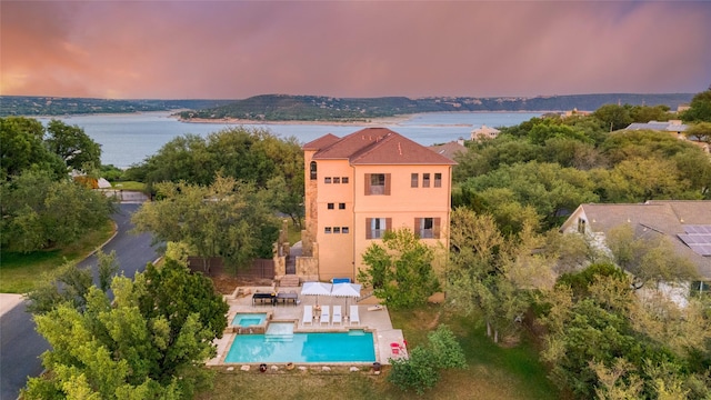 aerial view at dusk with a water view