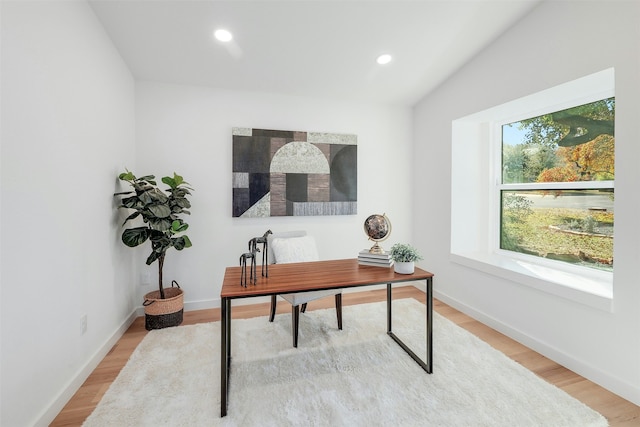 office featuring hardwood / wood-style flooring and lofted ceiling