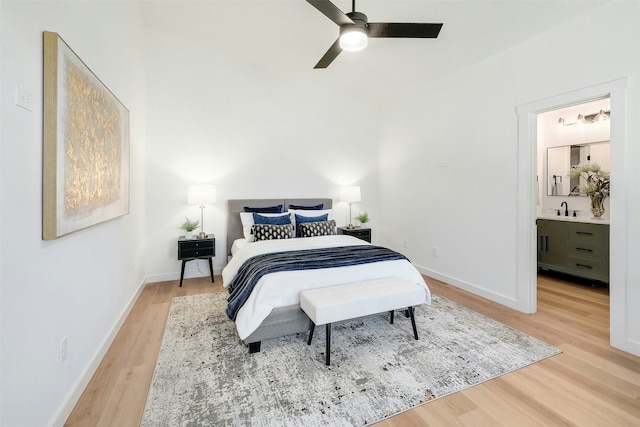 bedroom with sink, ensuite bath, hardwood / wood-style floors, and ceiling fan