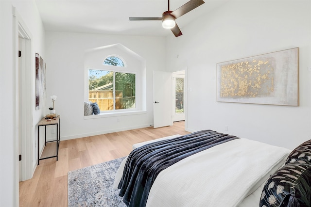 bedroom featuring vaulted ceiling, ceiling fan, and light wood-type flooring