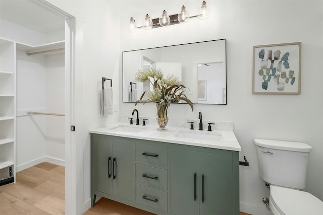 bathroom featuring vanity, toilet, and hardwood / wood-style floors