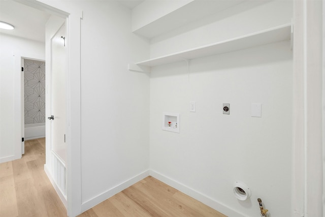 laundry area featuring hookup for a washing machine, hookup for an electric dryer, light hardwood / wood-style floors, and hookup for a gas dryer