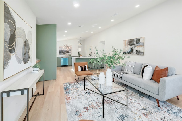 living room featuring an inviting chandelier and light hardwood / wood-style floors