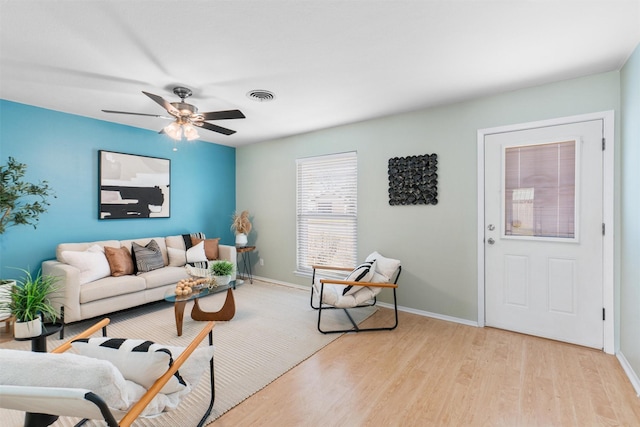 living room featuring ceiling fan and light hardwood / wood-style floors