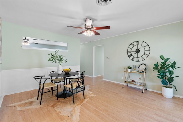 dining space with light hardwood / wood-style floors and ceiling fan