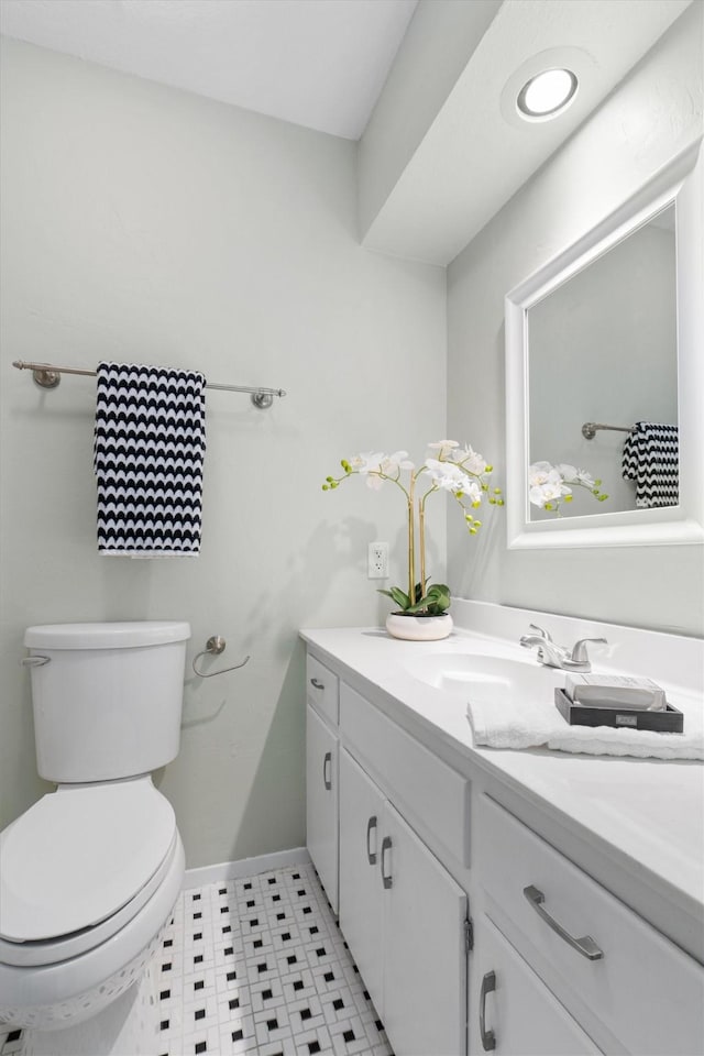 bathroom featuring vanity and toilet