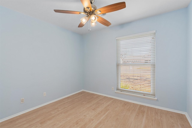 spare room with ceiling fan and light wood-type flooring