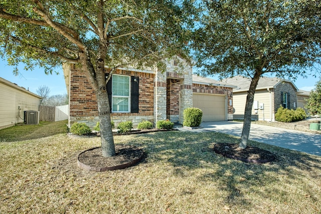 single story home featuring a garage, a front yard, and central air condition unit