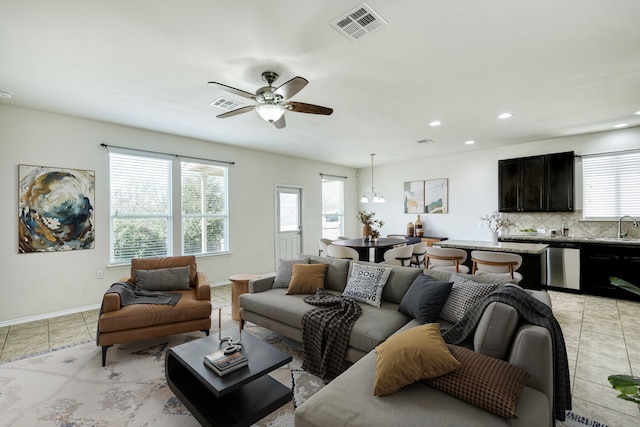 tiled living room with sink and ceiling fan