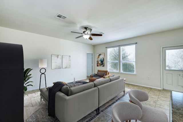 living room featuring ceiling fan and light tile patterned floors