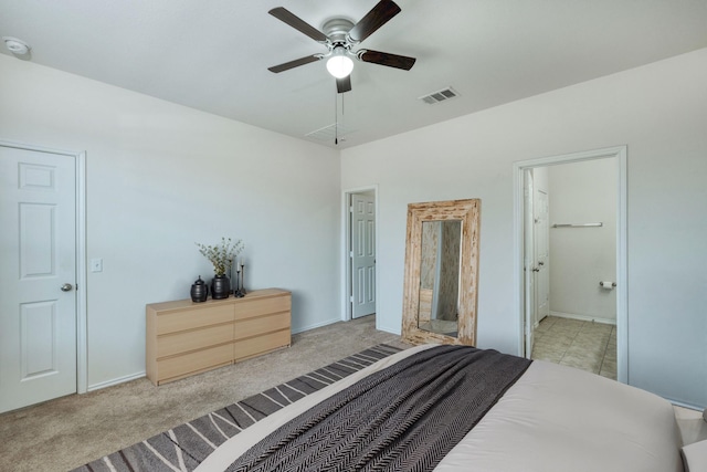 carpeted bedroom with ensuite bath and ceiling fan