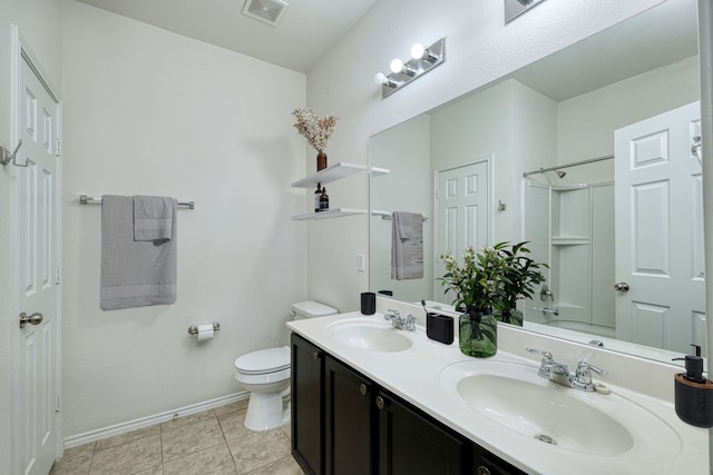 bathroom featuring tile patterned flooring, vanity, and toilet