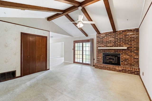unfurnished living room with carpet, a ceiling fan, a brick fireplace, and baseboards