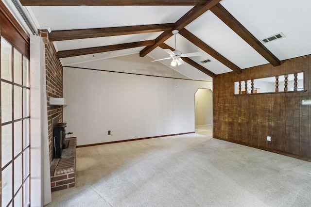 108 Fairlane Dr, Round Rock, TX 78664 - unfurnished living room with arched walkways, ceiling fan, healthy amount of natural light, carpet floors, and wooden walls