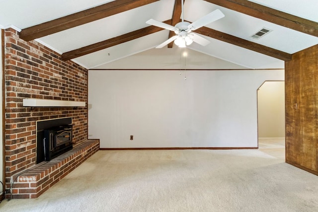 unfurnished living room with carpet floors, baseboards, and a wood stove