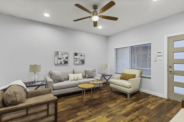 living room featuring ceiling fan and dark hardwood / wood-style floors