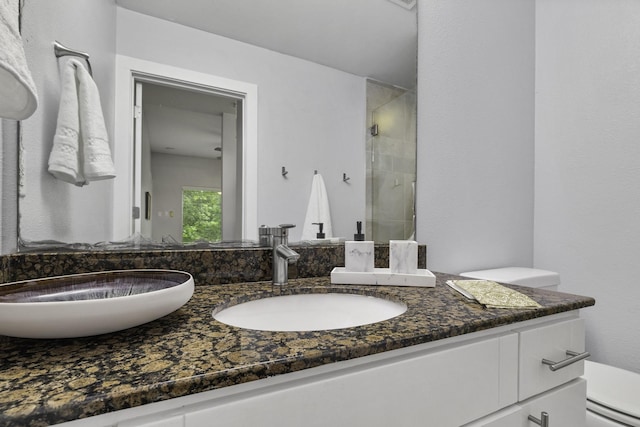 bathroom with vanity, a baseboard heating unit, a shower with shower door, and toilet