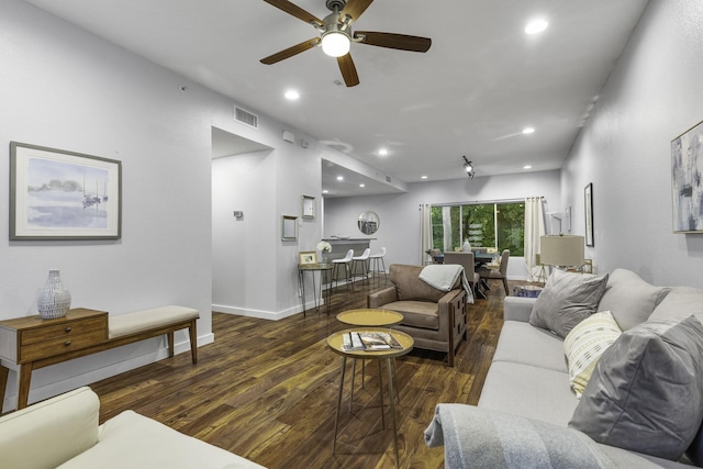 living room with ceiling fan and dark hardwood / wood-style floors