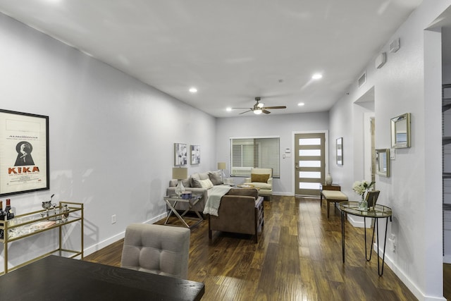 living room with dark wood-type flooring and ceiling fan