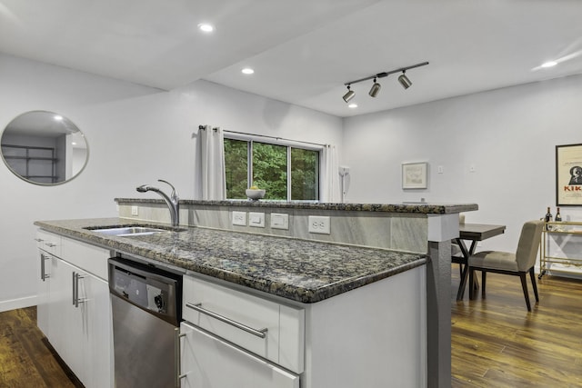 kitchen with sink, dark hardwood / wood-style floors, dishwasher, an island with sink, and white cabinets