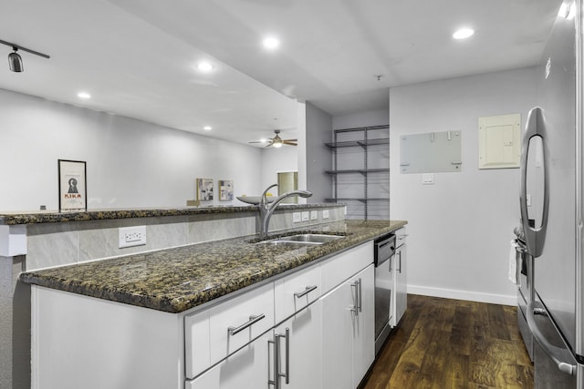 kitchen featuring a kitchen island, dark hardwood / wood-style floors, sink, white cabinets, and stainless steel appliances