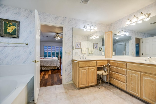 bathroom featuring vanity, a tub, tile patterned floors, and ceiling fan