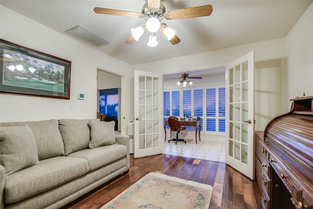 living room with hardwood / wood-style flooring, ceiling fan, and french doors