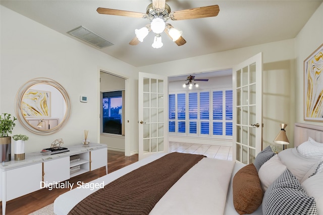 bedroom featuring french doors, ceiling fan, and light wood-type flooring