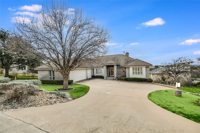 ranch-style home with a garage and a front yard