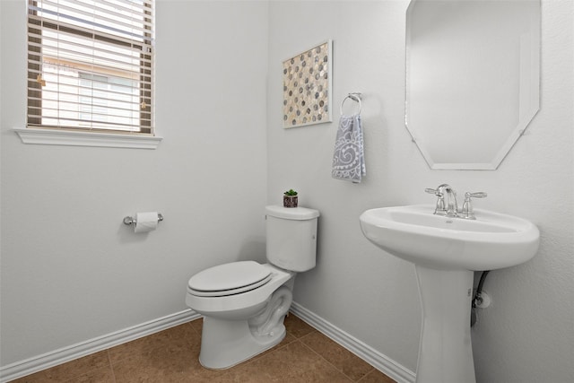 bathroom with toilet and tile patterned flooring