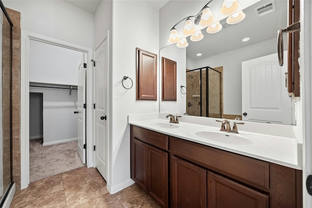 bathroom featuring vanity and a shower with shower door