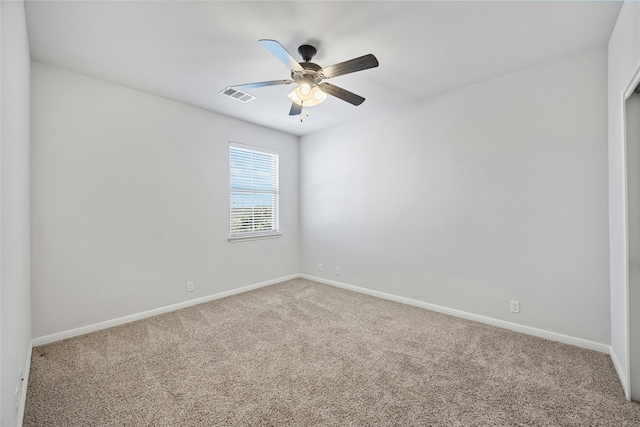 empty room featuring carpet floors and ceiling fan