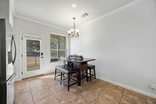 tiled dining room featuring crown molding and a chandelier