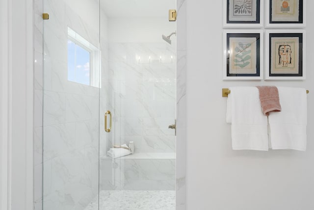 bathroom featuring a shower with door