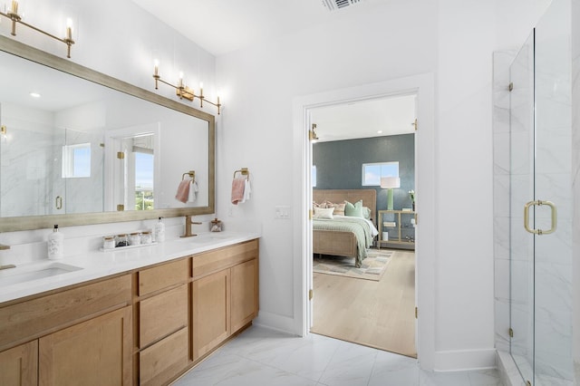 bathroom with vanity and a shower with shower door